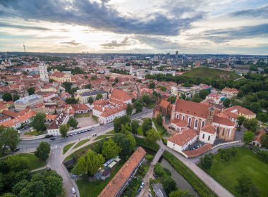 Vilnius Old Town with Many Old Streets and Cathedral Square and Bell Tower in Background. Lithuania. St. Johns Church Bell Tower and St. Anne Church