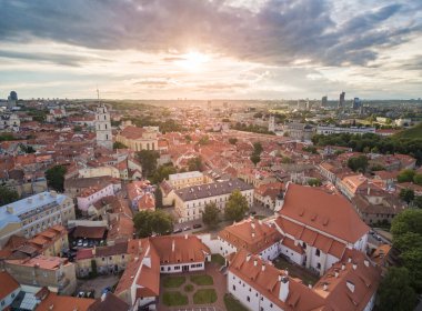 Vilnius Old Town with Many Old Streets and Cathedral Square and Bell Tower in Background. Lithuania. St. Johns Church Bell Tower. Sunset Light.