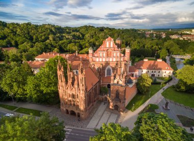 Vilnius Old Town and St. Anne Church with Hill of Three Crosses in Background. Lithuania. Sunset Light