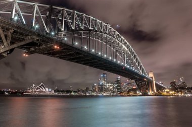 Sydney Harbour Bridge and Opera House at Night. Beautiful Sydney Cityscape and Skyline. Long Exposure. Flowing Sky. Australia