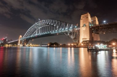 Sydney Harbour Bridge at Night. Long Exposure. Flowing Sky and Reflection on Water. Australia