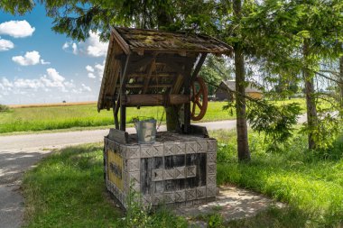 Beautiful Well with Bucket in Rural Area. Decorated. Country side in Lithuania