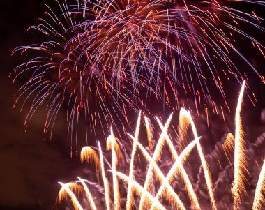 Brightly Colorful Fireworks Light Up the Sky. Beautiful New Year Fireworks. Dark Sky. Explosion. Abstract Colored Firework Background