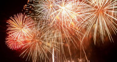 Brightly Colorful Fireworks Light Up the Sky. Beautiful New Year Fireworks. Dark Sky. Explosion. Abstract Colored Firework Background