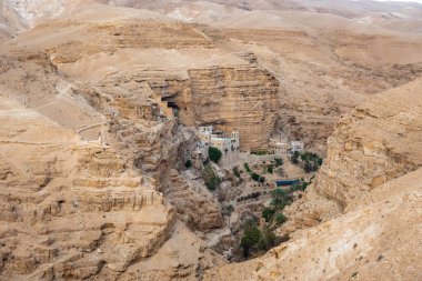 Wadi Qelt in Judean desert around St. George Orthodox Monastery, or Monastery of St. George of Choziba, Israel. The sixth-century cliff-hanging complex.
