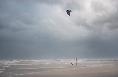 Stormy Mediterranean Sea and Cloudy Sky in Tel Aviv, Israel. Man with Power Kite
