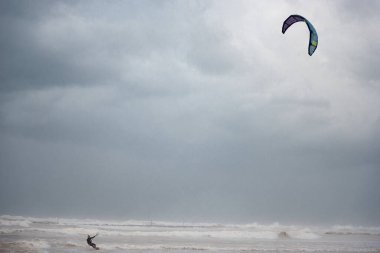 Stormy Mediterranean Sea and Cloudy Sky in Tel Aviv, Israel. Man with Power Kite