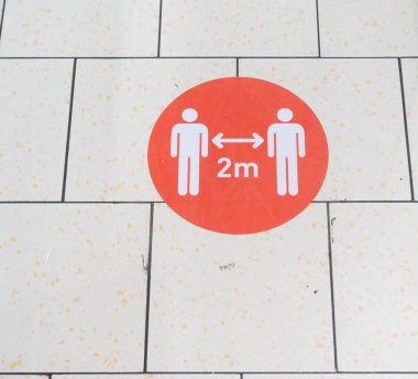 Covid19 Sign in Shopping Mall. Social Distancing Between People is Requiring in Public Places