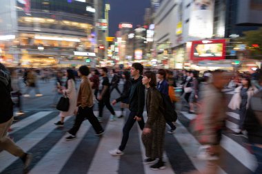 TOKYO, JAPAN - OCTOBER 30, 2019: Shibuya Crossing in Tokyo, Japan. The most famous intersection in the world. Blurry beacause of the panning.
