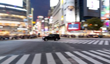 TOKYO, JAPAN - OCTOBER 30, 2019: Shibuya Crossing in Tokyo, Japan. The most famous intersection in the world. Blurry beacause of the panning.