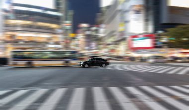 TOKYO, JAPAN - OCTOBER 30, 2019: Shibuya Crossing in Tokyo, Japan. The most famous intersection in the world. Blurry beacause of the panning.