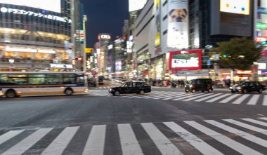 TOKYO, JAPAN - OCTOBER 30, 2019: Shibuya Crossing in Tokyo, Japan. The most famous intersection in the world. Blurry beacause of the panning.