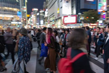 TOKYO, JAPAN - OCTOBER 30, 2019: Shibuya Crossing in Tokyo, Japan. The most famous intersection in the world. Blurry beacause of the panning.