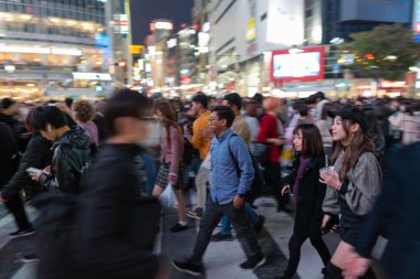 TOKYO, JAPAN - OCTOBER 30, 2019: Shibuya Crossing in Tokyo, Japan. The most famous intersection in the world. Blurry beacause of the panning.