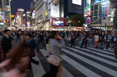TOKYO, JAPAN - OCTOBER 30, 2019: Shibuya Crossing in Tokyo, Japan. The most famous intersection in the world. Blurry beacause of the panning.