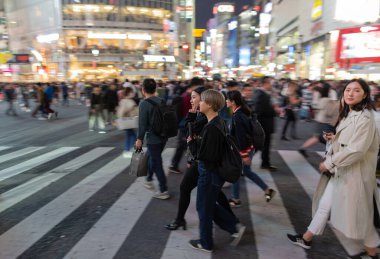 TOKYO, JAPAN - OCTOBER 30, 2019: Shibuya Crossing in Tokyo, Japan. The most famous intersection in the world. Blurry beacause of the panning.