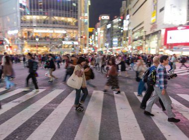 TOKYO, JAPAN - OCTOBER 30, 2019: Shibuya Crossing in Tokyo, Japan. The most famous intersection in the world. Blurry beacause of the panning.