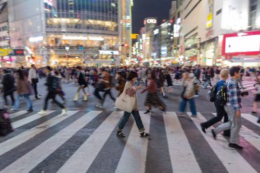 TOKYO, JAPAN - OCTOBER 30, 2019: Shibuya Crossing in Tokyo, Japan. The most famous intersection in the world. Blurry beacause of the panning.