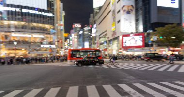 TOKYO, JAPAN - OCTOBER 30, 2019: Shibuya Crossing in Tokyo, Japan. The most famous intersection in the world. Blurry beacause of the panning.