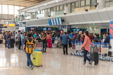 ROME, ITALY - OCTOBER 22, 2019: Rome international Leonardo da Vinci Fiumicino Airport interior with people. Departure area and Korean Air check-in desk.