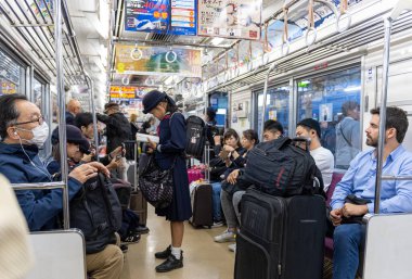 TOKYO, JAPAN - OCTOBER 24, 2019: Full People of Tokyo Train Car. People are traveling from airport to Tokyo City.  Keisei Main Line Rapid Limited Express