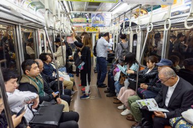 TOKYO, JAPAN - OCTOBER 25, 2019: Tokyo Metro Train and Car Full of People. Going Home after Work Day