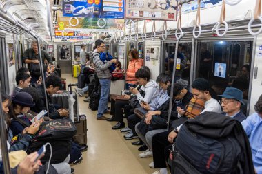 TOKYO, JAPAN - OCTOBER 24, 2019: Full People of Tokyo Train Car. People are traveling from airport to Tokyo City.  Keisei Main Line Rapid Limited Express