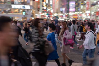 TOKYO, JAPAN - OCTOBER 30, 2019: Shibuya Crossing in Tokyo, Japan. The most famous intersection in the world. Blurry beacause of the panning.