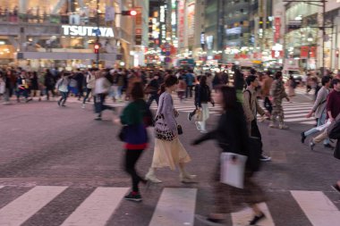 TOKYO, JAPAN - OCTOBER 30, 2019: Shibuya Crossing in Tokyo, Japan. The most famous intersection in the world. Blurry beacause of the panning.