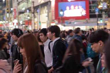 TOKYO, JAPAN - OCTOBER 30, 2019: Shibuya Crossing in Tokyo, Japan. The most famous intersection in the world. Blurry beacause of the panning.
