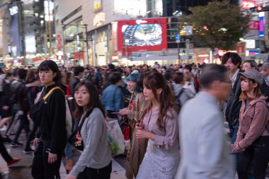 TOKYO, JAPAN - OCTOBER 30, 2019: Shibuya Crossing in Tokyo, Japan. The most famous intersection in the world. Blurry beacause of the panning.