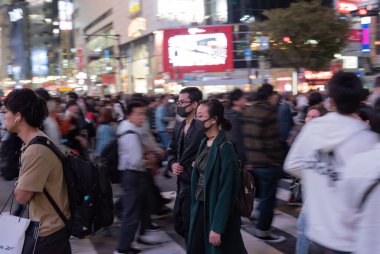 TOKYO, JAPAN - OCTOBER 30, 2019: Shibuya Crossing in Tokyo, Japan. The most famous intersection in the world. Blurry beacause of the panning.