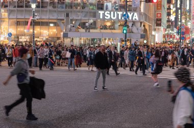 TOKYO, JAPAN - OCTOBER 30, 2019: Shibuya Crossing in Tokyo, Japan. The most famous intersection in the world. Blurry beacause of the panning.