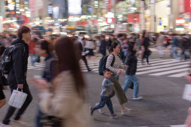 TOKYO, JAPAN - OCTOBER 30, 2019: Shibuya Crossing in Tokyo, Japan. The most famous intersection in the world. Blurry beacause of the panning.