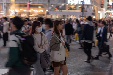 TOKYO, JAPAN - OCTOBER 30, 2019: Shibuya Crossing in Tokyo, Japan. The most famous intersection in the world. Blurry beacause of the panning.