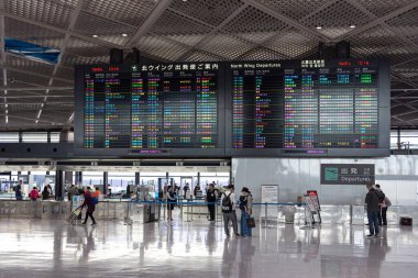 NARITA, JAPAN - OCTOBER 31, 2019: Narita International Airport with Screen and People in Background.