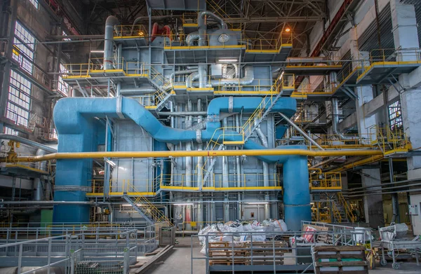 Industrial machines. Internal structure of large thermal power plant. The interior of an industrial boiler room with many pipes, valves and sensors. Steam turbine and electricity generator