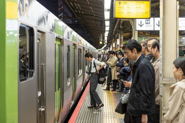 TOKYO, JAPAN - OCTOBER 30, 2019: Crowded Train Station in Japan, Tokyo.  People are Waiting for the Train.