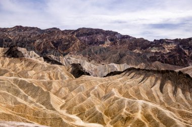 Zabriskie Point. It is a part of the Amargosa Range located east of Death Valley in Death Valley National Park in California, United States, noted for its erosional landscape. USA