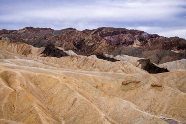 Zabriskie Point. It is a part of the Amargosa Range located east of Death Valley National Park in California, United States. One Man on the Top of Mountain.
