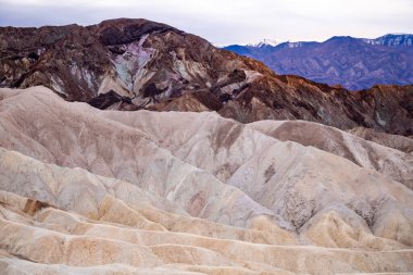 Zabriskie Point. It is a part of the Amargosa Range located east of Death Valley National Park in California, United States. One Man on the Top of Mountain.