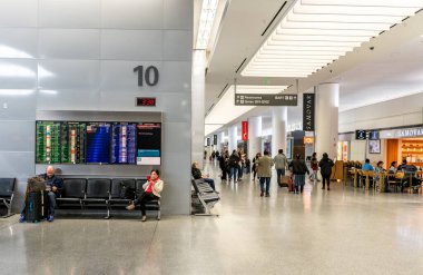 SAN FRANCISCO, CALIFORNIA - APRIL 04, 2019: San Francisco International Airport. Departure Area and People, Screen in Background.
