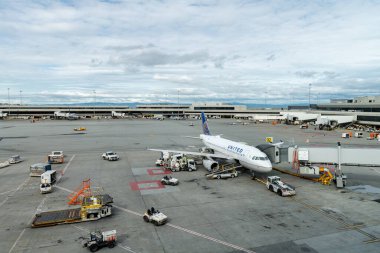 SAN FRANCISCO, CALIFORNIA - APRIL 04, 2019: San Francisco International Airport. United Airlines Boeing and Ground Service in Background