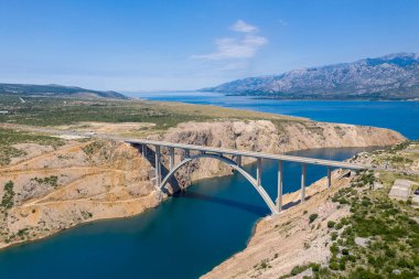 Maslenica Bridge Most in Croatia. The Maslenica Bridge is a deck arch bridge carrying the state road spanning the Novsko Zdrilo strait of the Adriatic Sea. Beautiful Landscape in Background.