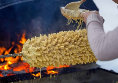 Sakotis is a Polish Lithuanian traditional spit cake. It is a cake made of butter, egg whites and yolks, flour, sugar, and cream, cooked on a rotating spit in an oven or over an open fire