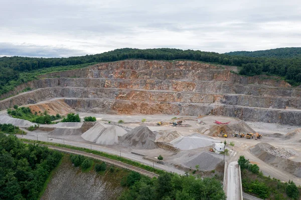 Stone Quarry in Croatia, Europe. Aerial View of Opencast Mining Quarry With Lots of Machinery. View from Above. Marble Mining Industry.