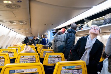 VILNIUS, LITHUANIA - JANUARY 15, 2020: People Boarding to Ryanair Airplane in Vilnius International Airport. Trip to London Stansted Airport.