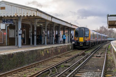 Train Station in Farnham, England. Soutth Western Railwai Train to London Waterloo station. People Are Waiting for Departure