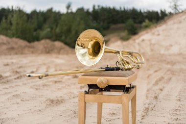 Trombone Music Instrument on the chair. Outdoor