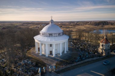 Holy Trinity Church in Suderve, Vilnius district, Lithuania. Cemetery in foreground.